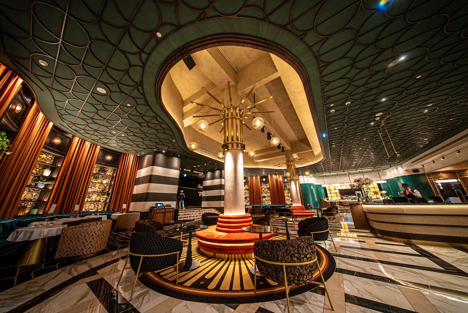 Cinema lounge with patterned ceiling and a central illuminated column
